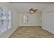Spacious bedroom featuring wood flooring, a ceiling fan, and natural light at 3906 W San Luis St, Tampa, FL 33629