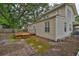 Exterior side view featuring a deck with stairs and brick pathway at 3906 W San Luis St, Tampa, FL 33629