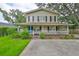 Charming two-story home featuring a welcoming wrap-around porch and nicely landscaped front yard at 3906 W San Luis St, Tampa, FL 33629