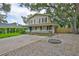 Two-story home with front porch, concrete driveway, gravel area and swing at 3906 W San Luis St, Tampa, FL 33629