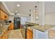Modern kitchen featuring granite countertops, wooden cabinets, and stainless steel appliances at 3906 W San Luis St, Tampa, FL 33629