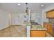 Updated kitchen featuring granite countertops, pendant lighting, tile flooring, and an open floor plan at 3906 W San Luis St, Tampa, FL 33629