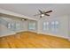 Bright living room with gleaming hardwood floors, open floor plan, and access to the stairs at 3906 W San Luis St, Tampa, FL 33629