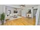 Bright living room boasts gleaming hardwood floors, a ceiling fan, and lots of natural light at 3906 W San Luis St, Tampa, FL 33629