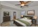 Comfortable main bedroom featuring a ceiling fan, neutral walls, and wood flooring at 3906 W San Luis St, Tampa, FL 33629