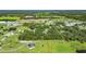 Overhead shot of a sizable parcel with open grassy spaces and mature trees, fully outlined and situated near other houses at 4312 James L Redman Pkwy, Plant City, FL 33567