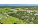 Wide-angle view of a vast landscape with lush greenery and scattered trees, revealing residential homes and agricultural fields nearby at 4312 James L Redman Pkwy, Plant City, FL 33567