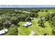 Picturesque view of a one-story home featuring dormer windows, a metal roof, and a nearby pond at 4312 James L Redman Pkwy, Plant City, FL 33567