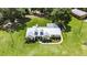 Scenic view of a one-story home with dormer windows, metal roof, and beautiful landscaping at 4312 James L Redman Pkwy, Plant City, FL 33567