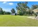Spacious backyard with a metal shed on a grassy lawn, offering ample space for outdoor activities and storage at 4312 James L Redman Pkwy, Plant City, FL 33567