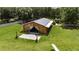 The barn has an open design, complemented by a brick pathway and well-maintained lawn, surrounded by nature at 4312 James L Redman Pkwy, Plant City, FL 33567