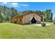 Large barn with white curtains, exterior plants, and manicured lawn at 4312 James L Redman Pkwy, Plant City, FL 33567
