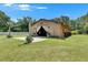 Large barn with white curtains, exterior plants, and manicured lawn at 4312 James L Redman Pkwy, Plant City, FL 33567