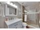 Bathroom featuring a single sink, a walk-in shower with gray tile surround, and modern fixtures at 4312 James L Redman Pkwy, Plant City, FL 33567