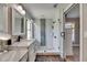 Bathroom featuring double sinks, a walk-in shower with tile surround, and modern fixtures at 4312 James L Redman Pkwy, Plant City, FL 33567