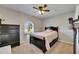 Bedroom featuring soft carpet, a sunny window view to the outdoors, and dark wood furniture at 4312 James L Redman Pkwy, Plant City, FL 33567