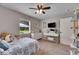 Bedroom featuring soft carpet, a ceiling fan, and a sunny window view to the outdoors at 4312 James L Redman Pkwy, Plant City, FL 33567