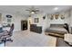 Bedroom featuring tile floors, ceiling fan, deer heads and gun safe at 4312 James L Redman Pkwy, Plant City, FL 33567