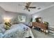 Relaxing bedroom featuring a comfortable bed, ample natural light, and decorative accents at 4312 James L Redman Pkwy, Plant City, FL 33567