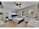 Bedroom featuring soft carpet, a ceiling fan, and a sunny window view to the outdoors at 4312 James L Redman Pkwy, Plant City, FL 33567