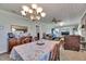 Cozy dining area with a floral tablecloth, chandelier, and adjacent living area, creating a warm and inviting atmosphere at 4312 James L Redman Pkwy, Plant City, FL 33567