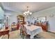 Elegant dining room with chandelier, wooden furniture, and a display cabinet at 4312 James L Redman Pkwy, Plant City, FL 33567