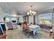 Inviting dining room with a chandelier, decorative ceiling, and ample natural light, perfect for Gathering gatherings at 4312 James L Redman Pkwy, Plant City, FL 33567