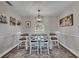 Bright dining room with wainscoting, a decorative light fixture, and an adjacent view to the outside at 4312 James L Redman Pkwy, Plant City, FL 33567