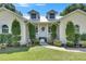 Inviting entrance of a home with a well-maintained lawn and decorative shrubbery along the walkway at 4312 James L Redman Pkwy, Plant City, FL 33567