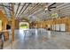 Open event space with a soaring ceiling, fans, and set up with tables and chairs at 4312 James L Redman Pkwy, Plant City, FL 33567