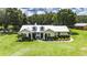Beautiful one-story home featuring dormer windows, a metal roof, and exquisite landscaping at 4312 James L Redman Pkwy, Plant City, FL 33567