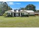 Charming single-story home with a manicured lawn and lush landscaping, creating inviting curb appeal at 4312 James L Redman Pkwy, Plant City, FL 33567