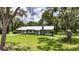 Charming single-story home with a well-manicured lawn and mature trees creating a serene and inviting curb appeal at 4312 James L Redman Pkwy, Plant City, FL 33567