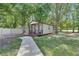 Charming cottage-style home with a cozy front porch and picturesque landscaping at 4312 James L Redman Pkwy, Plant City, FL 33567