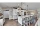 Bright, open kitchen with a large island, white cabinetry, and modern pendant lighting creating a stylish atmosphere at 4312 James L Redman Pkwy, Plant City, FL 33567