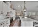 Spacious kitchen with white cabinets, a large island, and a seamless view into the dining and living areas at 4312 James L Redman Pkwy, Plant City, FL 33567