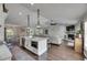 Bright open-concept layout with a kitchen island flowing into the living room with brick fireplace at 4312 James L Redman Pkwy, Plant City, FL 33567