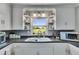 Updated kitchen with white cabinets, granite counters, and a view of the expansive yard at 4312 James L Redman Pkwy, Plant City, FL 33567