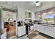 Bright kitchen with white cabinets, stainless steel appliances, and an open doorway at 4312 James L Redman Pkwy, Plant City, FL 33567