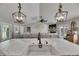 Stylish kitchen island with a modern faucet, pendant lights, and seamless transition to the cozy living room at 4312 James L Redman Pkwy, Plant City, FL 33567