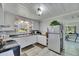 Charming kitchen with white cabinets, updated appliances, and a bright window view at 4312 James L Redman Pkwy, Plant City, FL 33567