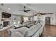 Open-concept living room with a brick fireplace, comfortable seating, and hardwood floors throughout at 4312 James L Redman Pkwy, Plant City, FL 33567