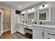 Main bathroom featuring double sinks with marble countertops, modern fixtures, and a walk-in shower at 4312 James L Redman Pkwy, Plant City, FL 33567