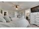 Spacious main bedroom featuring soft carpet, a ceiling fan, and an ensuite bathroom at 4312 James L Redman Pkwy, Plant City, FL 33567