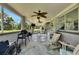 Relaxing covered patio featuring comfortable seating, ceiling fans, and a view of the lush outdoor surroundings at 4312 James L Redman Pkwy, Plant City, FL 33567