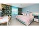 Tranquil bedroom with soft pink and blue hues and large windows that provide natural light at 500 Glennes Ln # 202, Dunedin, FL 34698