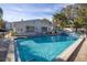 Community pool with clear blue water and sunny skies at 500 Glennes Ln # 202, Dunedin, FL 34698