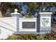 Sign for a 55+ community with landscaping at 500 Glennes Ln # 202, Dunedin, FL 34698