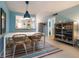 Charming dining area with seating for four, a modern light fixture, and a colorful striped rug at 500 Glennes Ln # 202, Dunedin, FL 34698