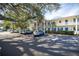 Exterior daytime view of condo building with parking in front at 500 Glennes Ln # 202, Dunedin, FL 34698